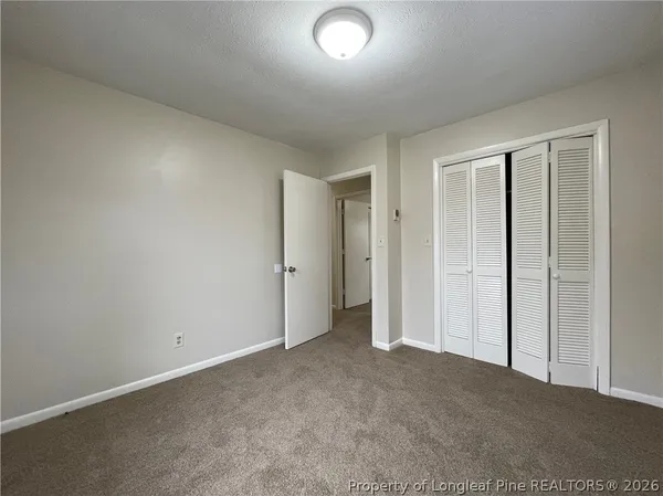 an empty room with closet area