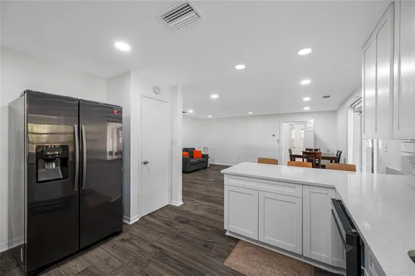 a kitchen with a sink appliances and cabinets