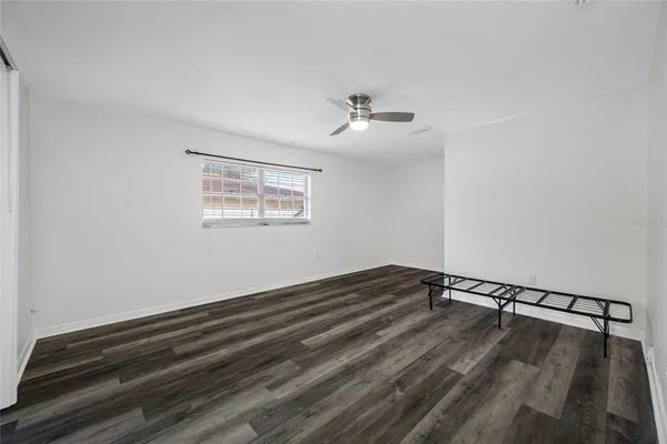 a view of empty room with wooden floor