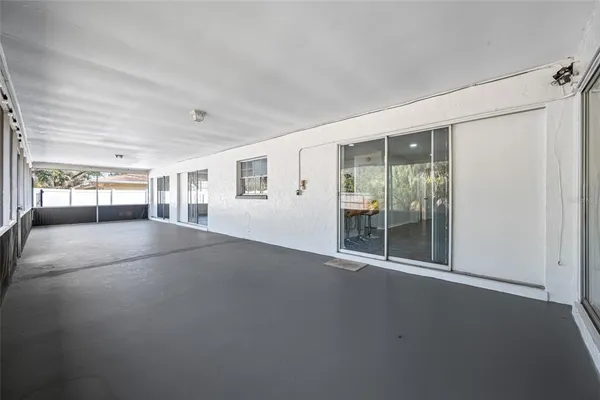 a view of empty room with large windows