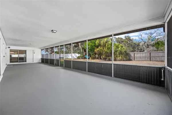 an empty room with wooden floor and mirror