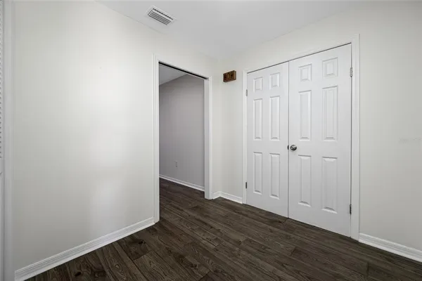 a living room with furniture a wooden floor and a window