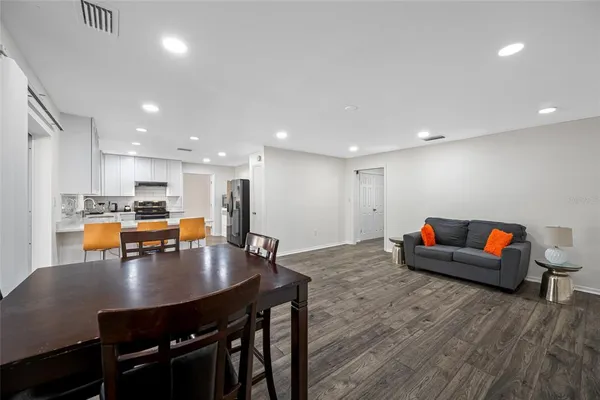 a view of a dining room with furniture and wooden floor