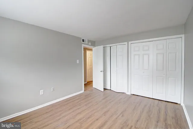 a view of an empty room and wooden floor