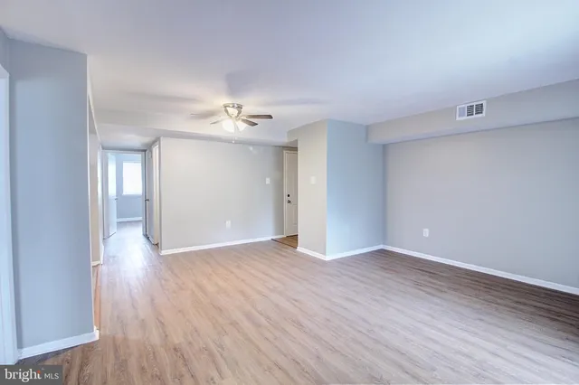a view of an empty room with wooden floor