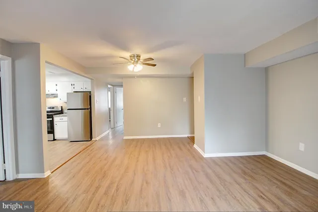 a view of a kitchen with wooden floor and a kitchen