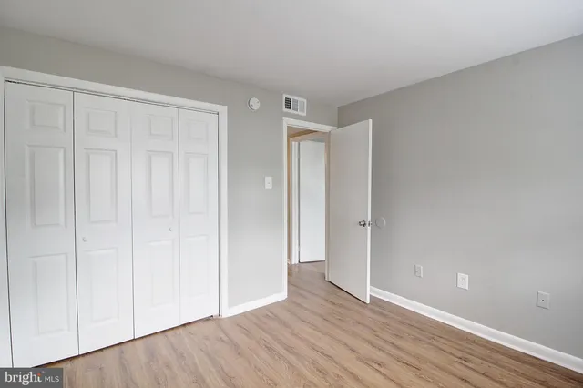 a view of an empty room and wooden floor