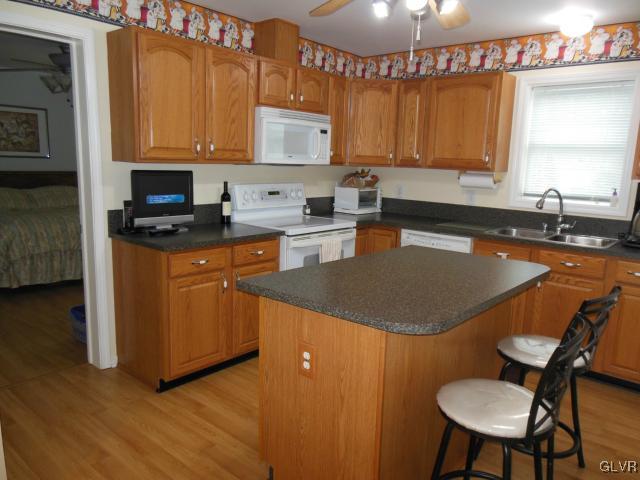 2147 Whitehead Road Nazareth, PA 18064 - Photo 21 of 35 a kitchen with stainless steel appliances granite countertop a sink a stove a microwave a refrigerator and cabinets