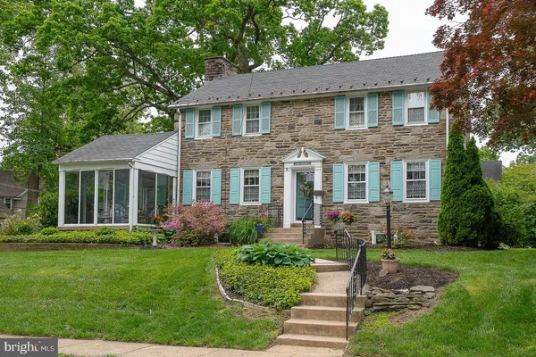 a front view of a house with a yard and porch