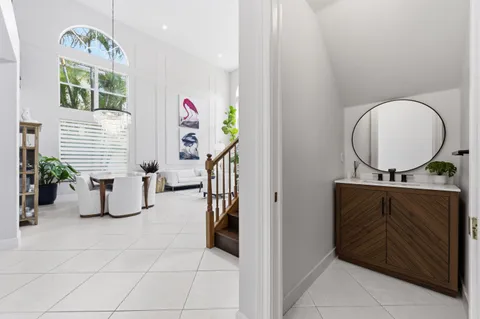 a bathroom with a sink mirror and window