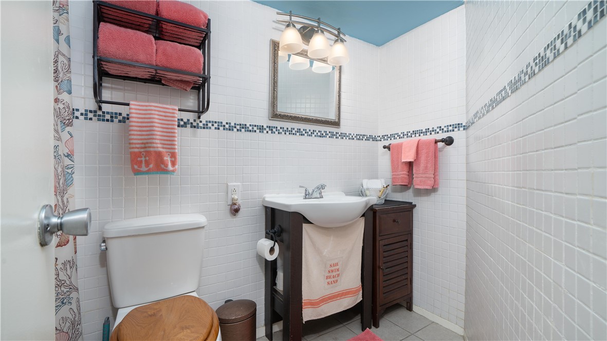 2290 North Fulton Beach Road Rockport, TX 78382 - Photo 17 of 26 a bathroom with a sink toilet and mirror