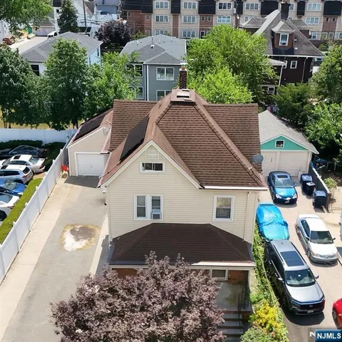 a aerial view of a house with a yard and balcony