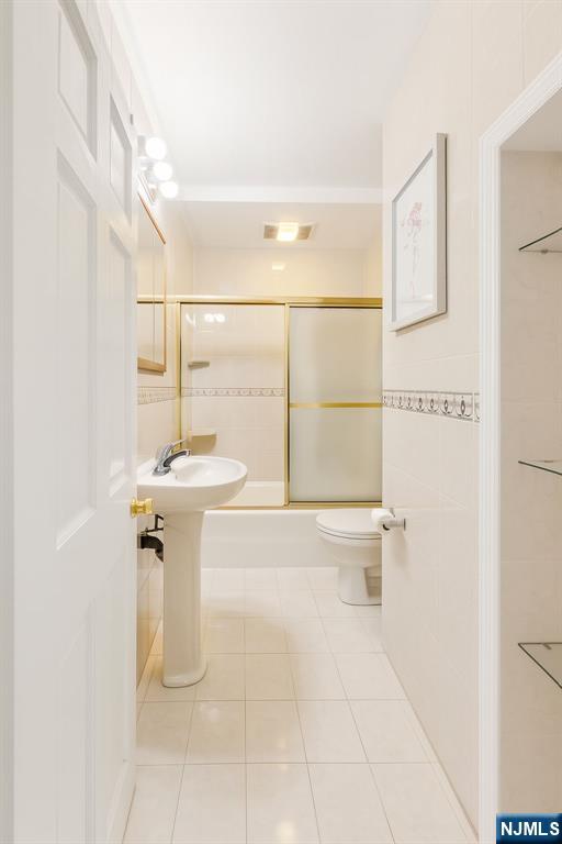 309 Lookout Avenue Hackensack, NJ 07601 - Photo 9 of 25 a bathroom with a sink a toilet and shower