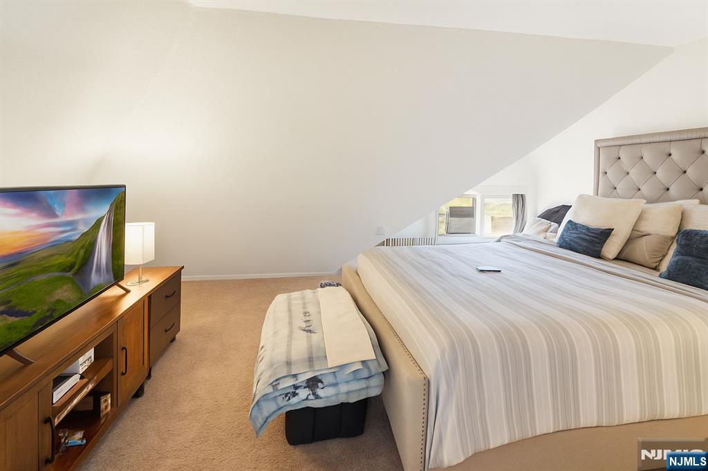 309 Lookout Avenue Hackensack, NJ 07601 - Photo 10 of 25 a bedroom with a bed and a flat screen tv