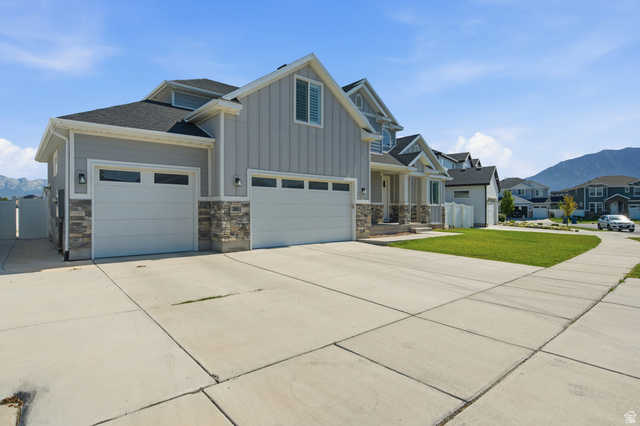 36 West Syracuse Road Vineyard, UT 84059 - Photo 4 of 56 Contemporary residential exterior featuring light gray siding and stone accents
