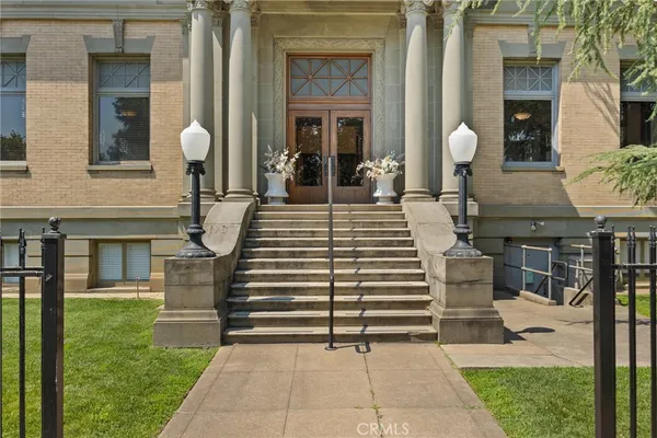 a view of a house with a chairs and a table in patio
