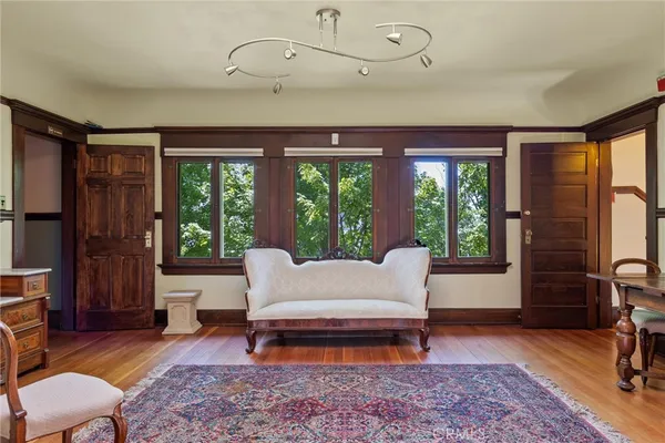 a living room with furniture a rug and a table