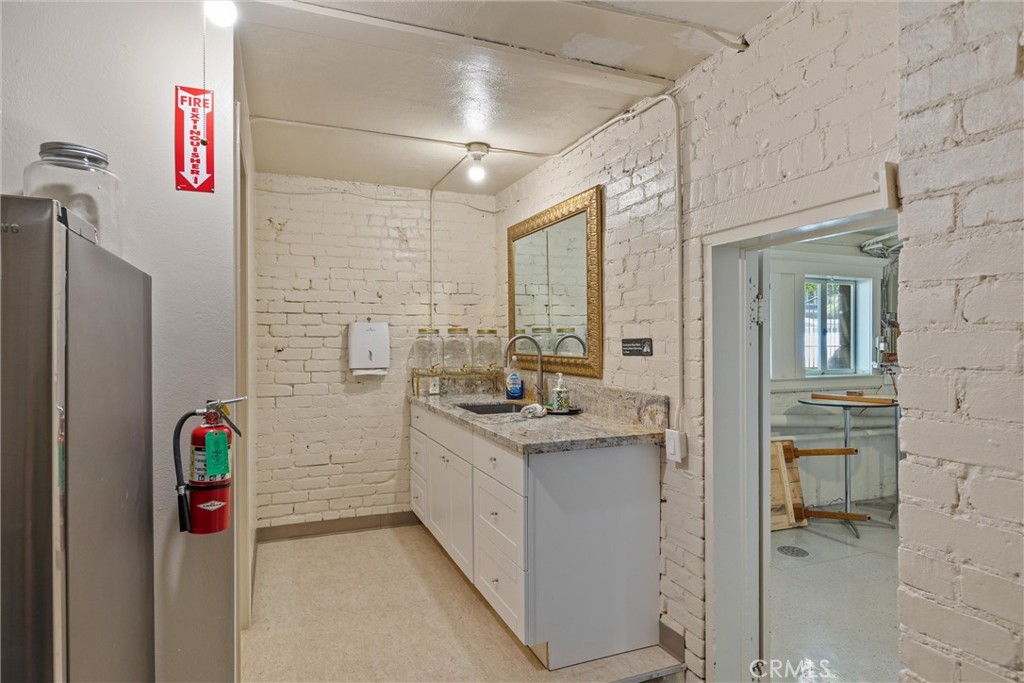 909 Jefferson Street Red Bluff, CA 96080 - Photo 32 of 41 a bathroom with a granite countertop sink a shower and a mirror