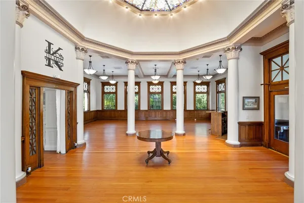 a room with lots of large windows and furniture