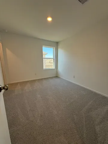 a view of an empty room and a window