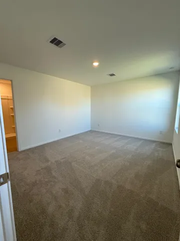 an empty room with a empty space and windows