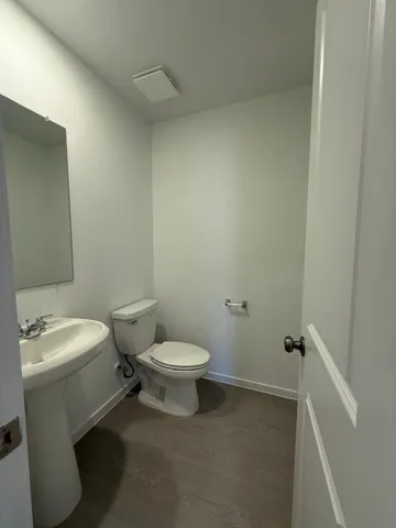 a white toilet sitting next to a white sink