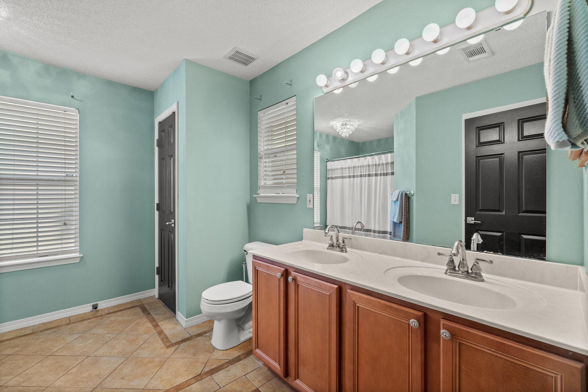 125 Bayou Landing Road Miramar Beach, FL 32550 - Photo 14 of 21 a bathroom with a double vanity sink and a mirror