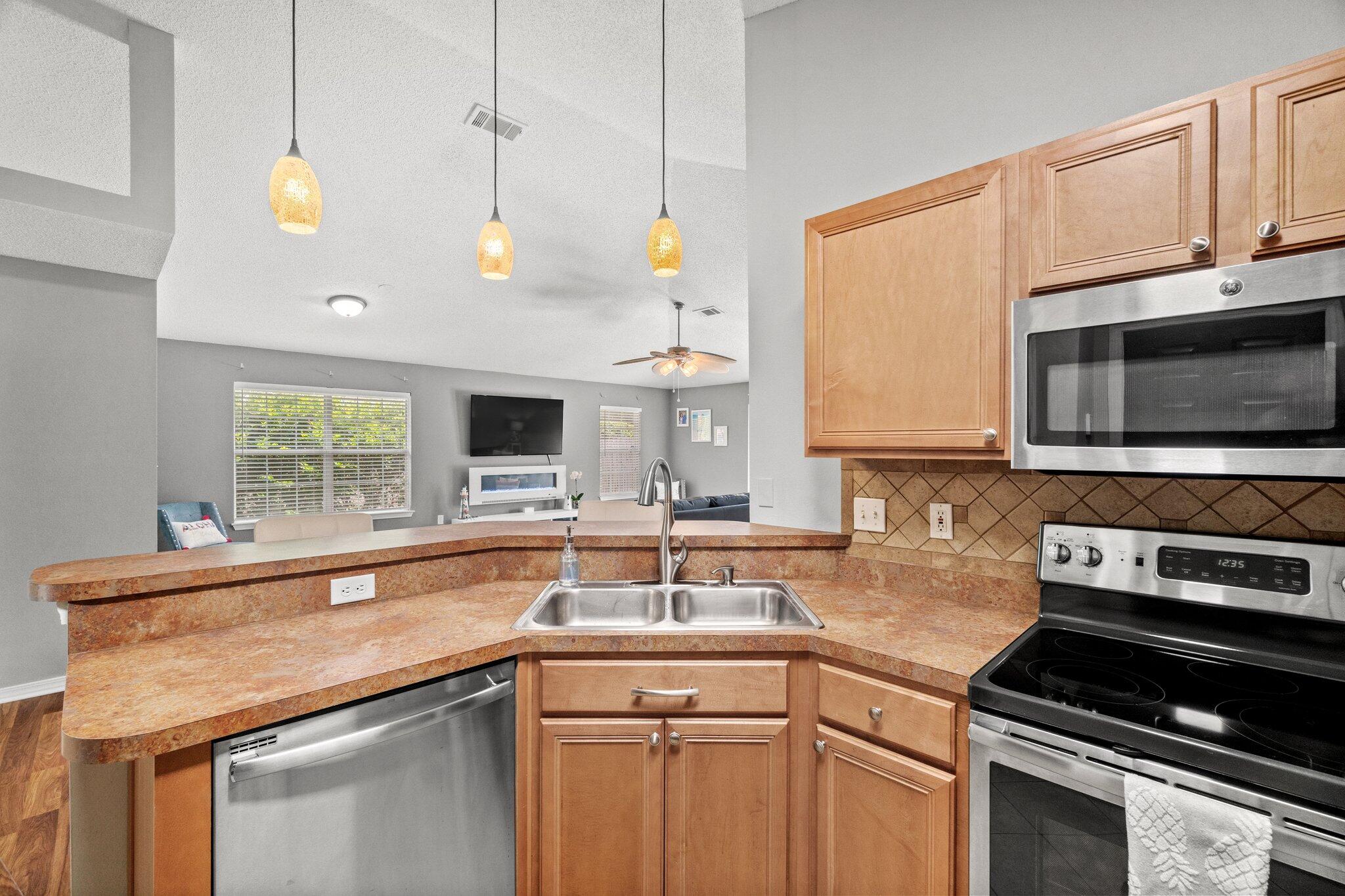 125 Bayou Landing Road Miramar Beach, FL 32550 - Photo 7 of 21 a kitchen with stainless steel appliances a sink a stove and a microwave