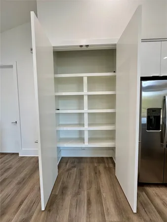 a view of walk in closet with empty racks