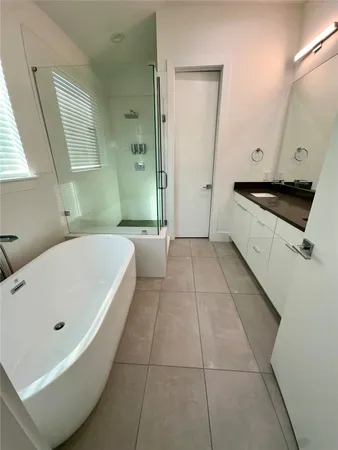 a bathroom with a bathtub and a sink