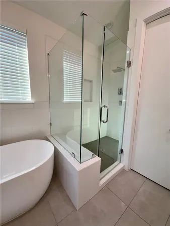a bathroom with a tub and shower