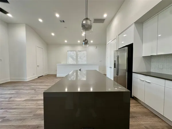 a view of kitchen with refrigerator and window