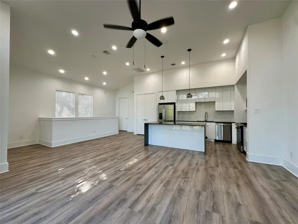 a view of kitchen with cabinets and wooden floor