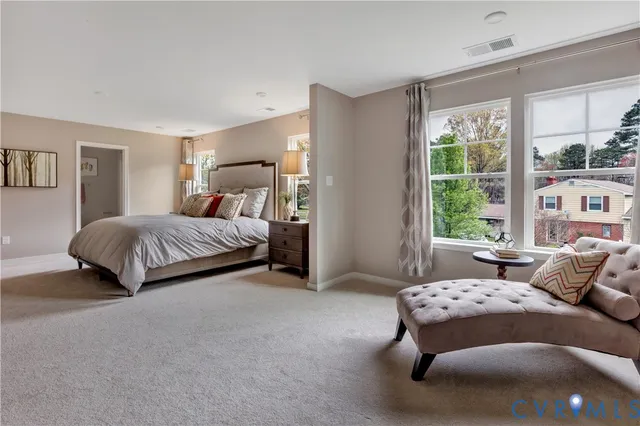 a bedroom with a bed and a couch