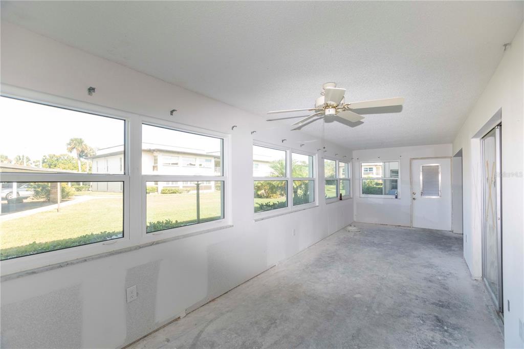 4715 Jasper Drive, Unit 107 New Port Richey, FL 34652 - Photo 11 of 22 a view of an empty room with a window