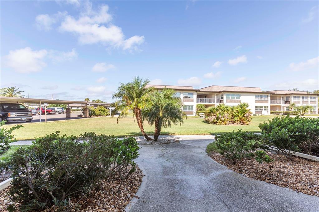 4715 Jasper Drive, Unit 107 New Port Richey, FL 34652 - Photo 4 of 22 a view of swimming pool outdoor seating and lake