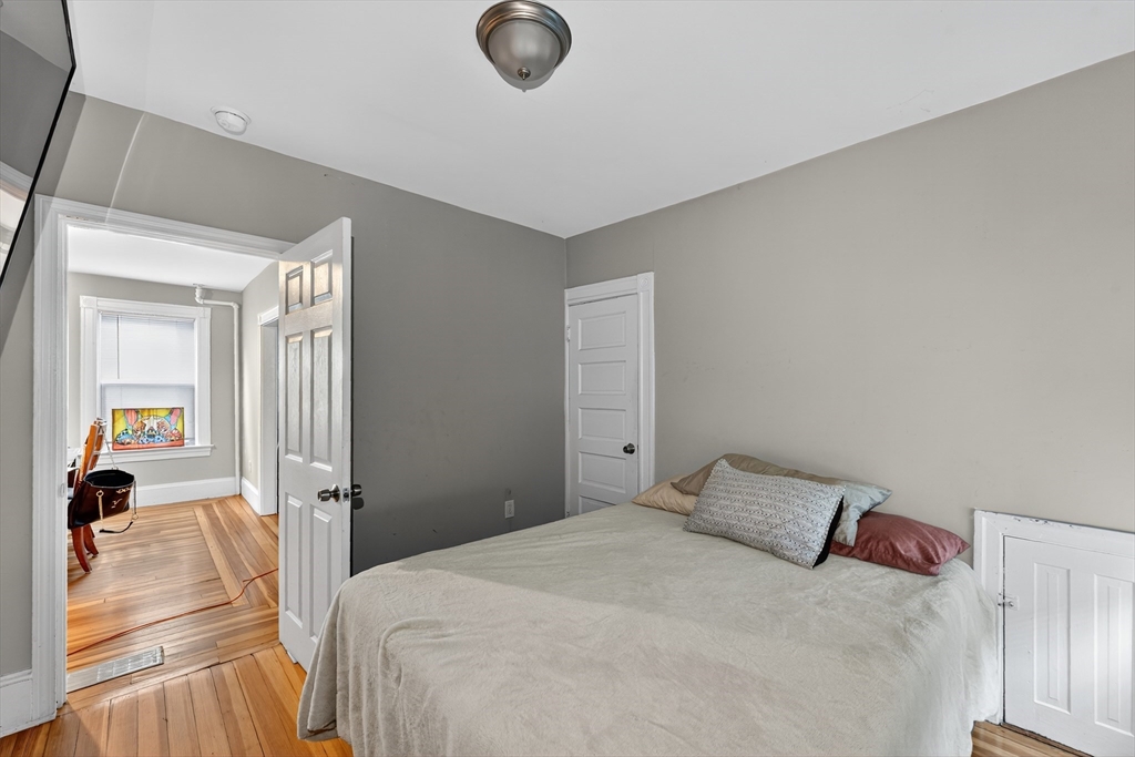 24-26 Pendleton Street Cranston, RI 02920 - Photo 20 of 25 a bedroom with a bed and a large window