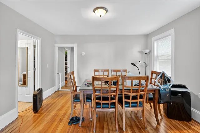 a living room with chairs and a wooden floor