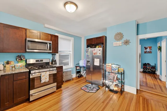a kitchen with stainless steel appliances stove top oven and cabinets