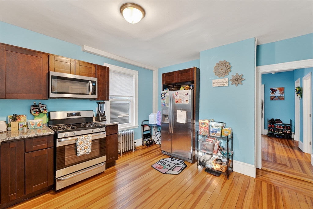 24-26 Pendleton Street Cranston, RI 02920 - Photo 3 of 25 a kitchen with stainless steel appliances stove top oven and cabinets