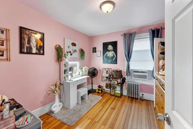 a bedroom with furniture and a window