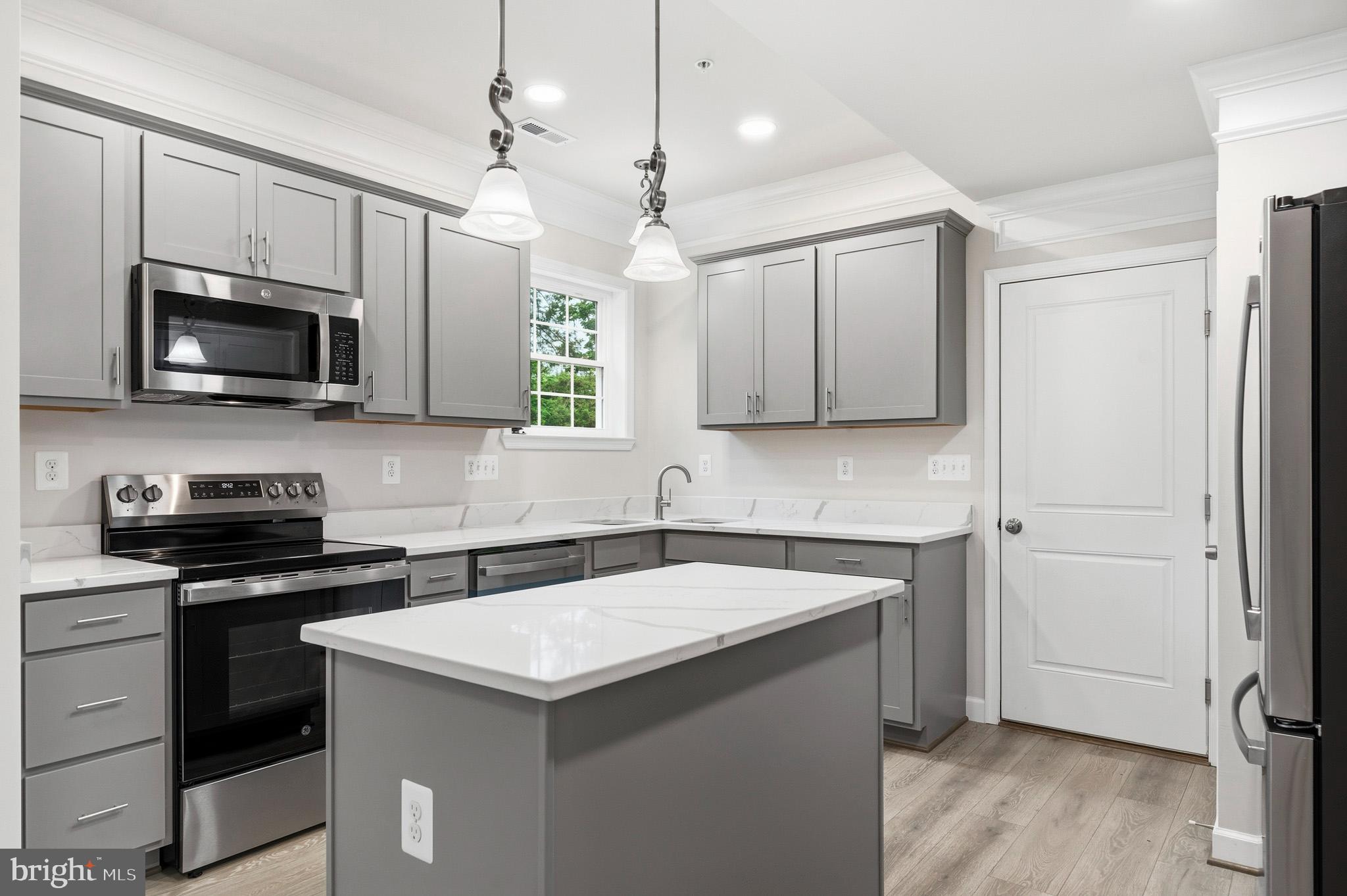 29725 Bruce Road Mechanicsville, MD 20659 - Photo 43 of 79 a kitchen with a sink a stove and microwave