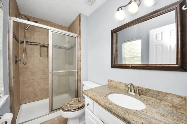 a view of a house with a yard and sitting area