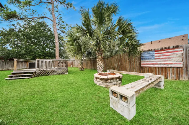 a view of a house with a yard and sitting area
