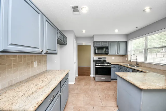 a kitchen with a stove and a sink