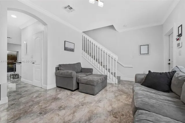 a living room with furniture and a rug