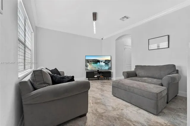 a living room with furniture and a flat screen tv