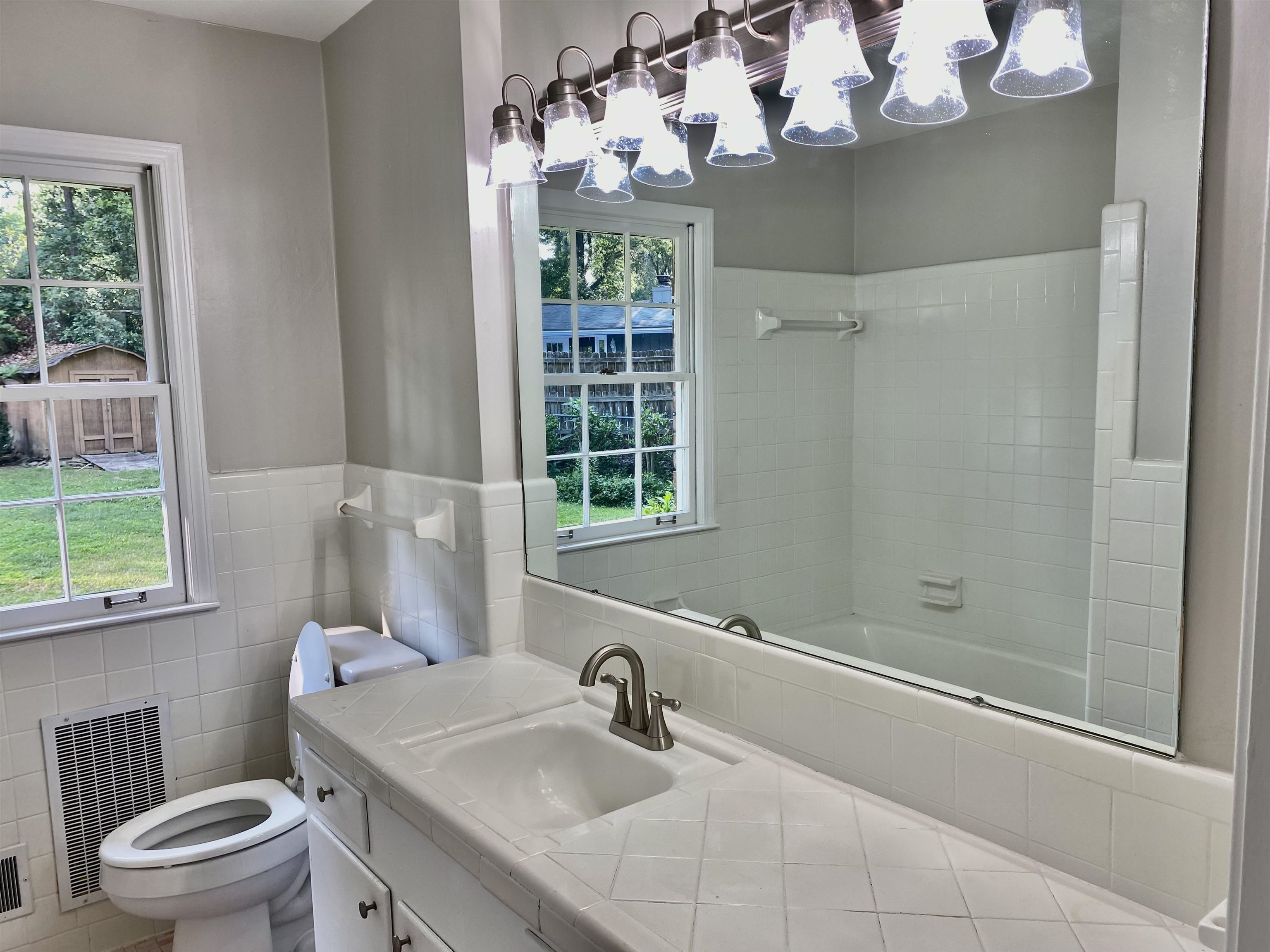 16 Jefferson Drive Rome, GA 30165 - Photo 12 of 26 a bathroom with a sink a mirror and a toilet