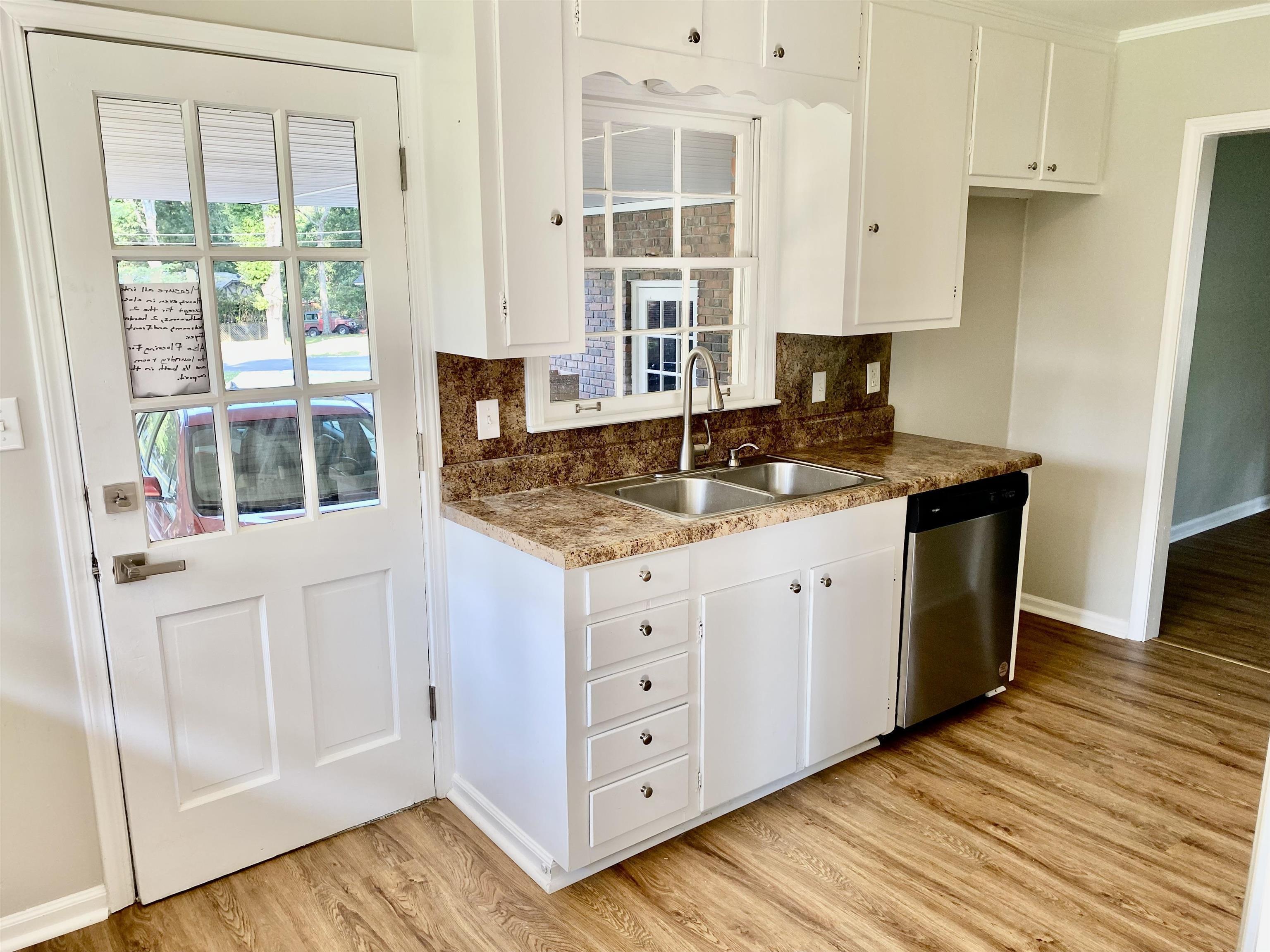 16 Jefferson Drive Rome, GA 30165 - Photo 4 of 26 a kitchen with stainless steel appliances granite countertop a stove a sink and white cabinets with wooden floor