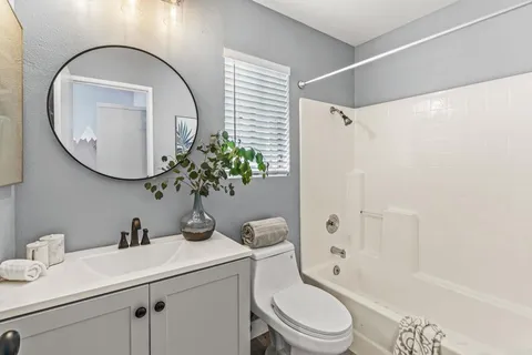 a bedroom with a bed and flat screen tv